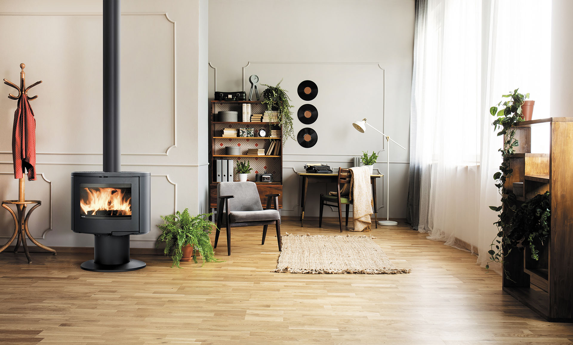 Lamp above table with plant in grey apartment interior with armc